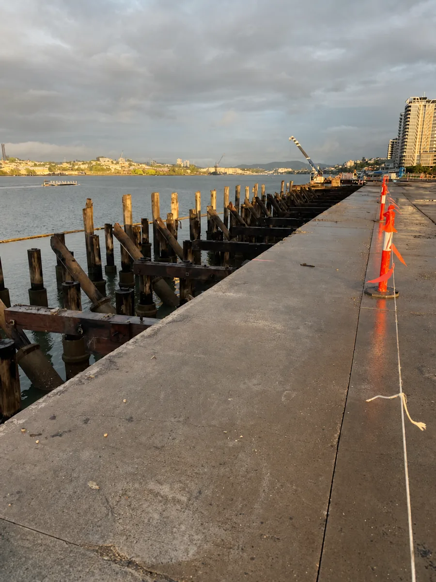 Exposed timber and steel wharf piles along Hamilton Reach in Brisbane