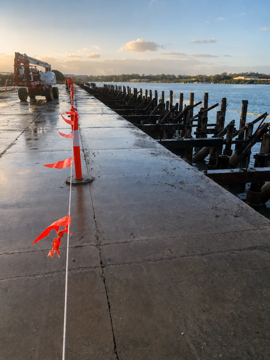 Hamilton Wharf demolition boundary with plant and exposed river piles